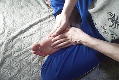Massages her feet with essential oils and enjoys herself