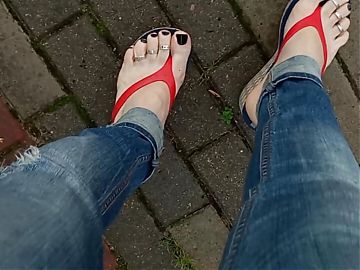 a crossdresser with sexy feet in flip flops is tempting on the street